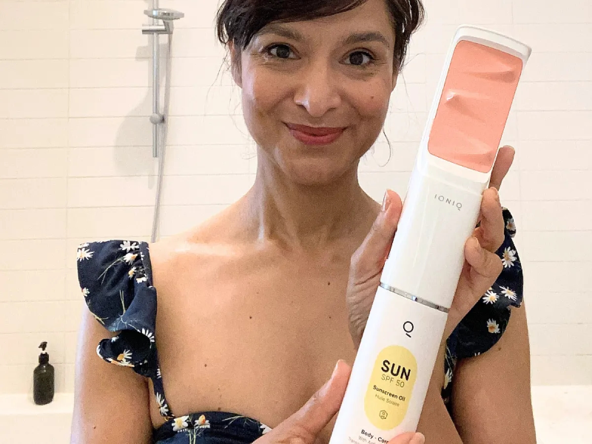 Frau hält den ONE Sprayer von IONIQ Skincare mit der Kartusche SUN mit SPF 50 in der Hand